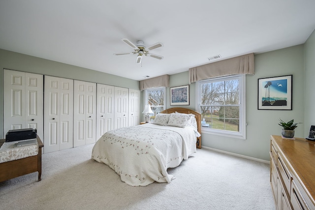 bedroom featuring carpet, visible vents, baseboards, and ceiling fan