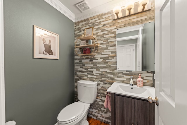 bathroom featuring toilet, vanity, ornamental molding, backsplash, and tile walls