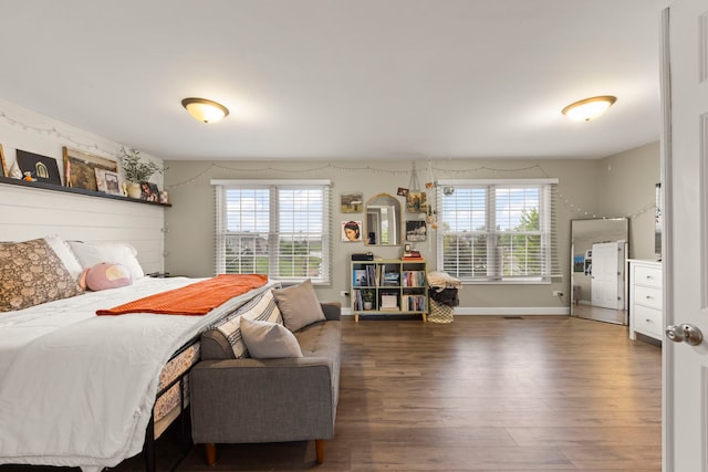 bedroom with wood finished floors and baseboards