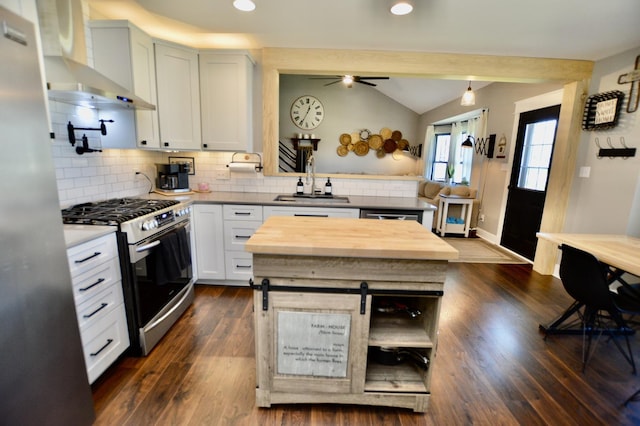 3707 Geneva Pl, Mchenry, IL 60050 - kitchen with decorative backsplash, appliances with stainless steel finishes, vaulted ceiling, a sink, and wall chimney exhaust hood
