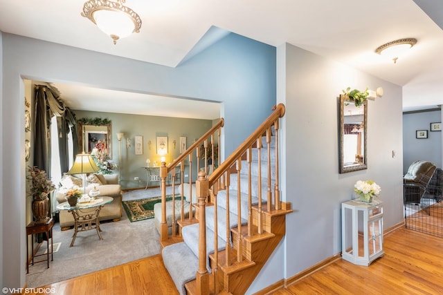 stairs with baseboards and wood finished floors