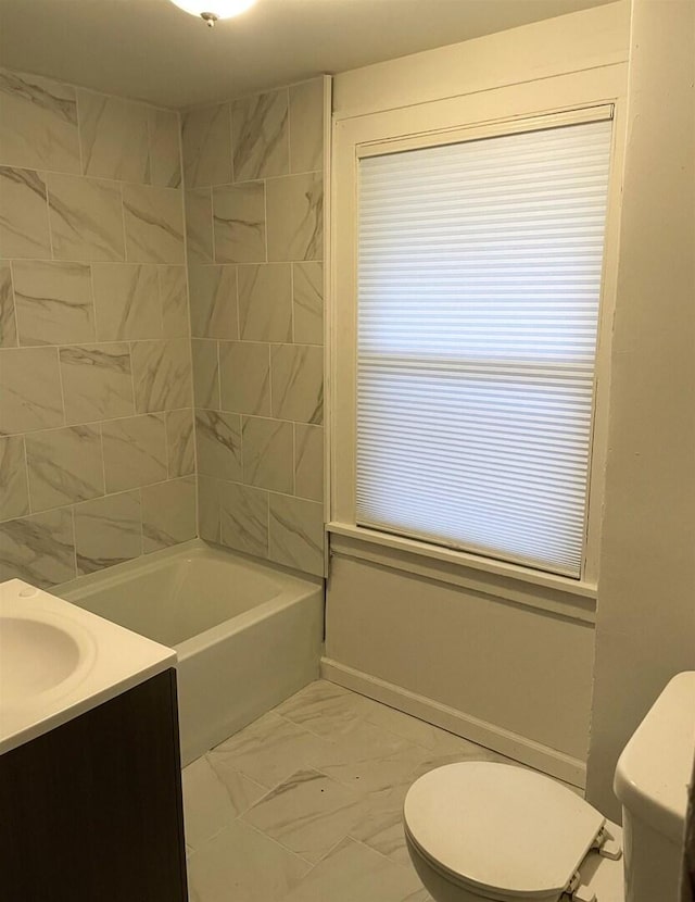 full bathroom with marble finish floor, toilet, vanity, and shower / bathing tub combination