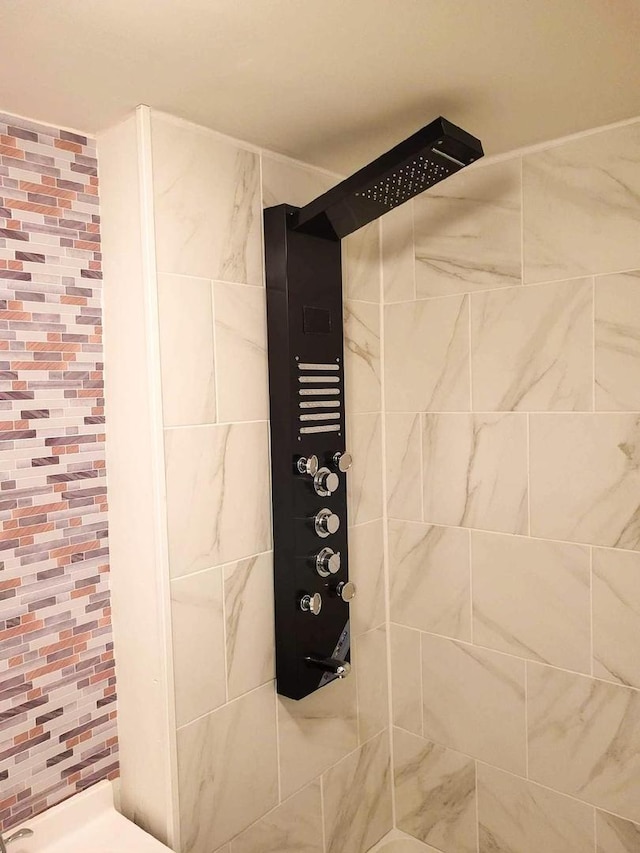 full bath with a tile shower