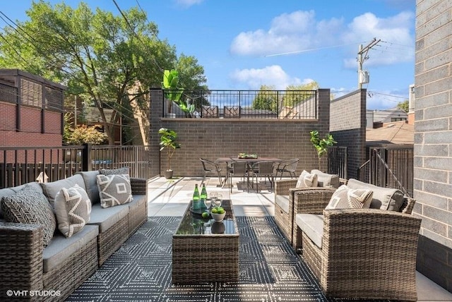 view of patio featuring outdoor lounge area and fence