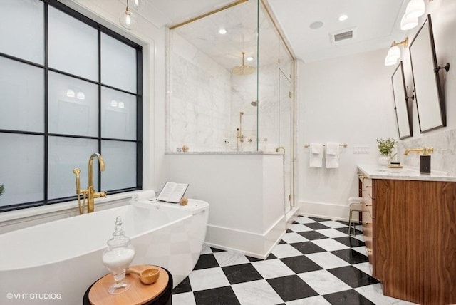 bathroom with a shower stall, tile patterned floors, a freestanding bath, baseboards, and visible vents