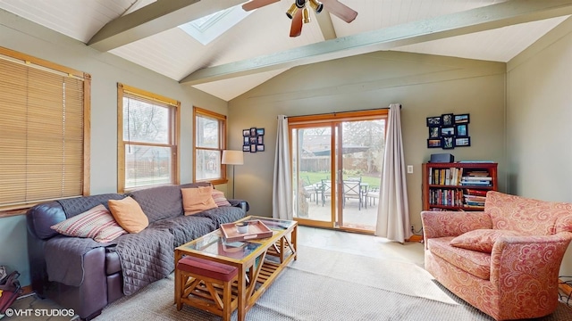 living room with lofted ceiling with skylight, ceiling fan, and light carpet