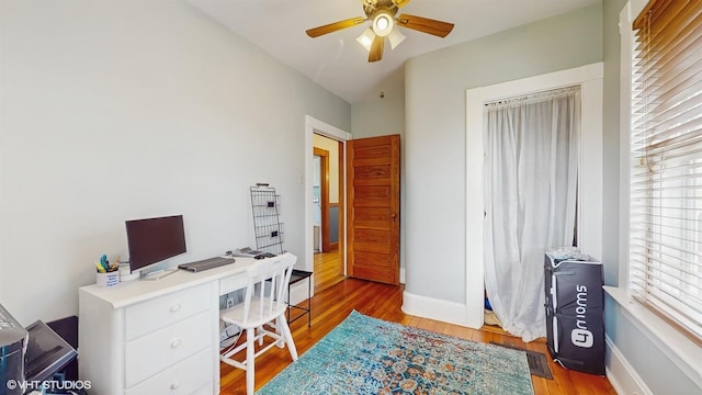 office with baseboards, wood finished floors, and a ceiling fan