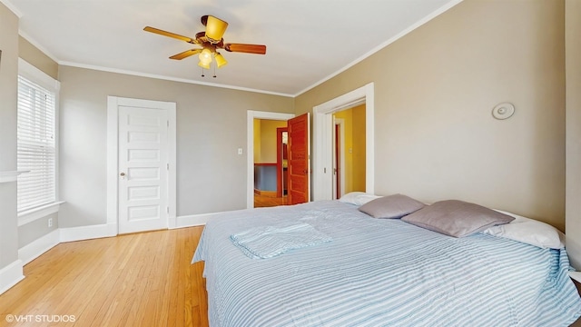 bedroom featuring crown molding, ceiling fan, light wood-style flooring, and baseboards