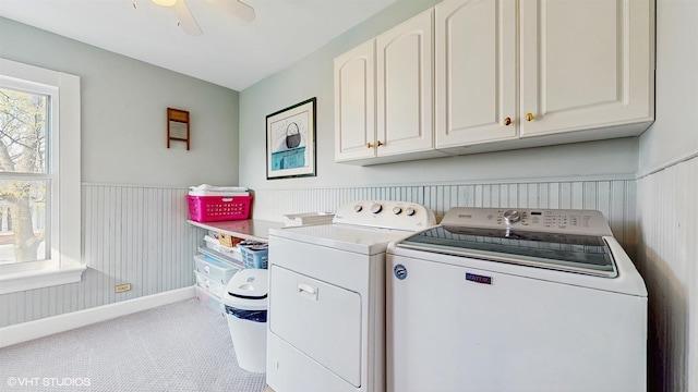 washroom featuring wainscoting, cabinet space, washing machine and clothes dryer, light carpet, and ceiling fan