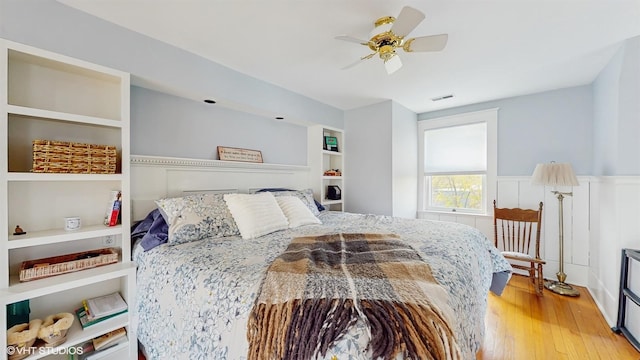 bedroom featuring visible vents, a ceiling fan, and light wood-style floors