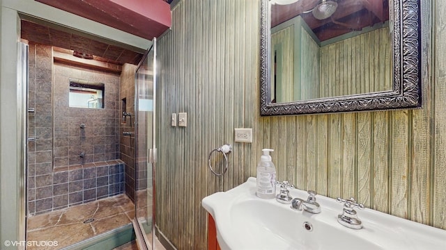 full bath with a sink and a shower stall