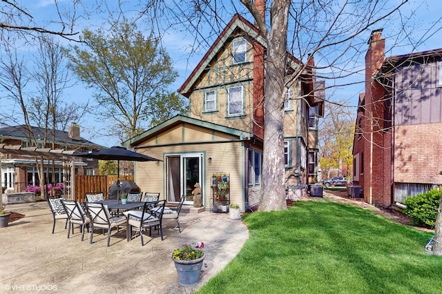 back of property with a patio area, a yard, cooling unit, entry steps, and fence