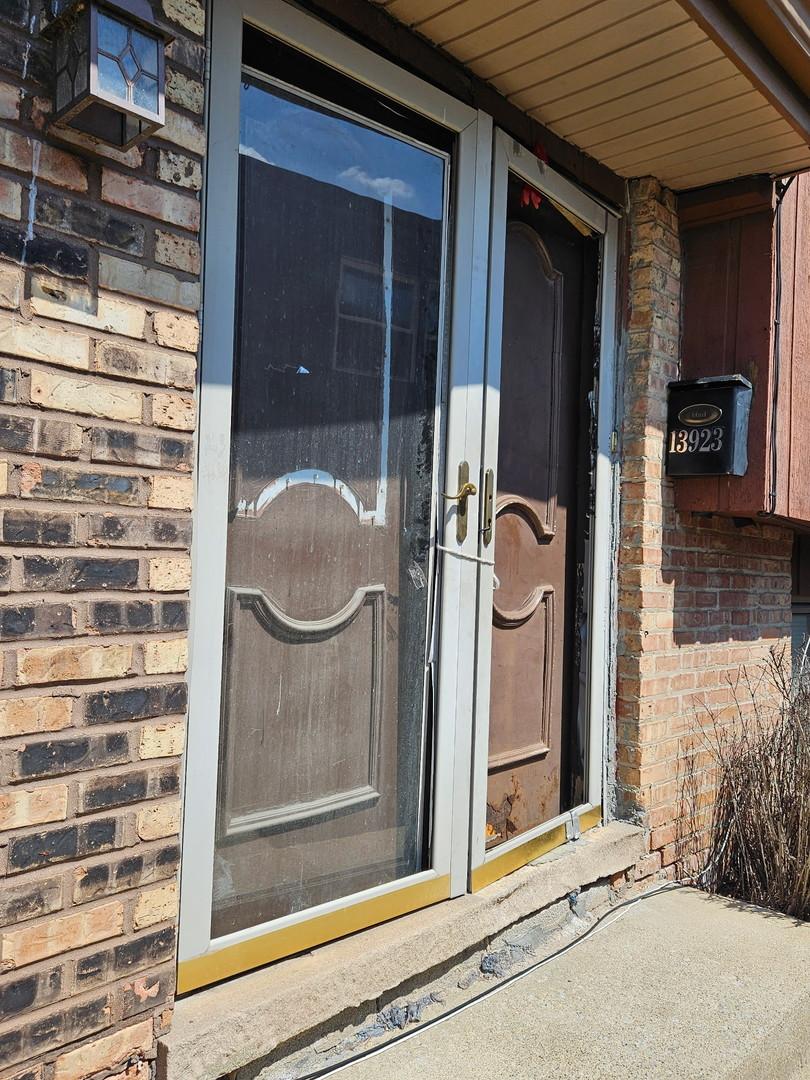 entrance to property with brick siding
