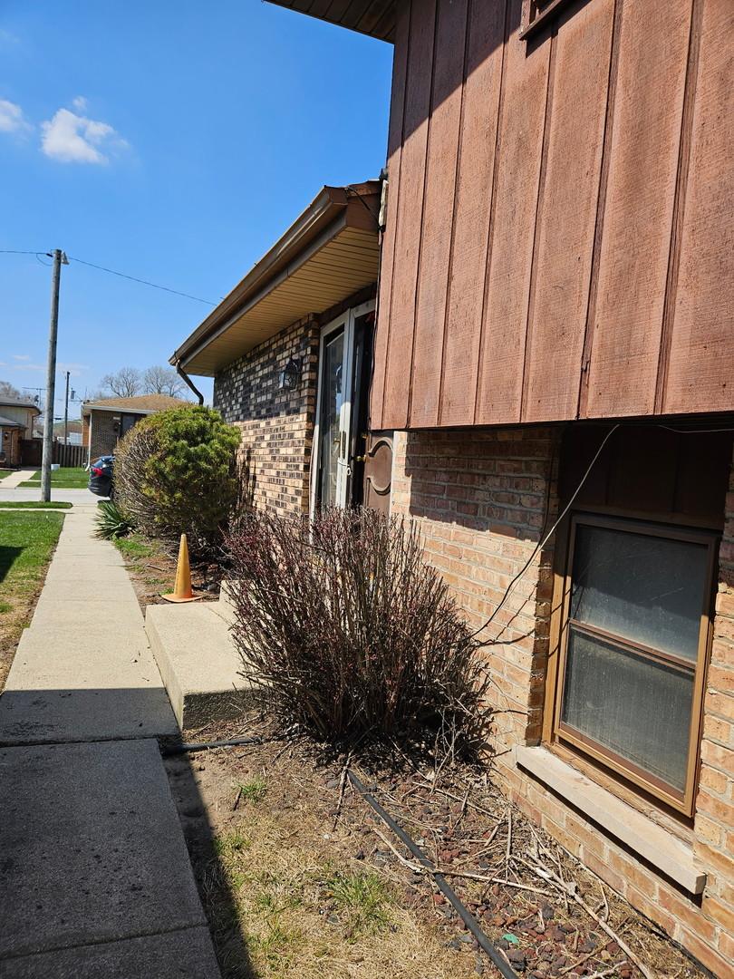 view of side of home with brick siding