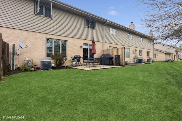 7654 W 158th Ct, Orland Park, IL 60462 - back of house featuring a patio, central air condition unit, a lawn, a chimney, and fence