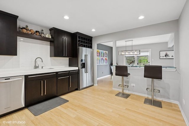7654 W 158th Ct, Orland Park, IL 60462 - kitchen with open shelves, a sink, stainless steel appliances, light countertops, and backsplash