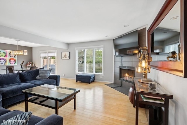 7654 W 158th Ct, Orland Park, IL 60462 - living room with baseboards, an inviting chandelier, a tile fireplace, recessed lighting, and wood finished floors