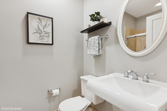 bathroom featuring toilet and a sink