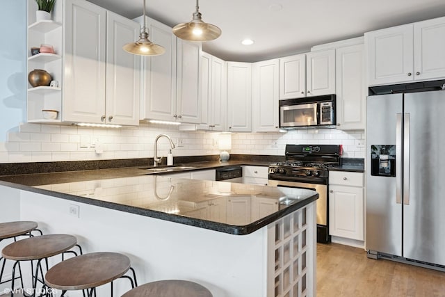 kitchen with a sink, a peninsula, open shelves, stainless steel appliances, and white cabinets