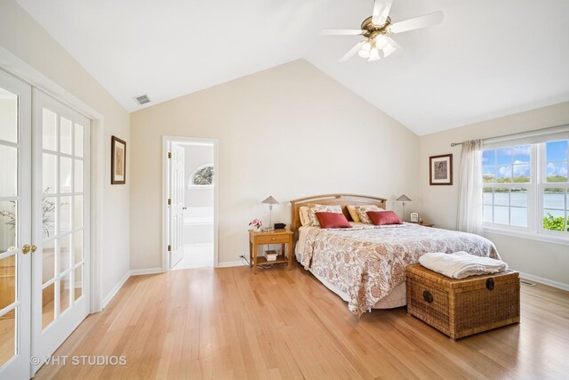bedroom with a ceiling fan, visible vents, vaulted ceiling, and light wood-type flooring