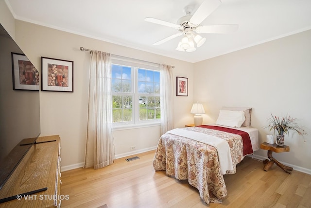 bedroom with baseboards, visible vents, and light wood finished floors