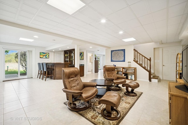 living room with recessed lighting, a dry bar, stairs, and light tile patterned flooring