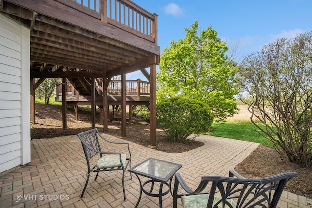 view of patio featuring stairway and a deck