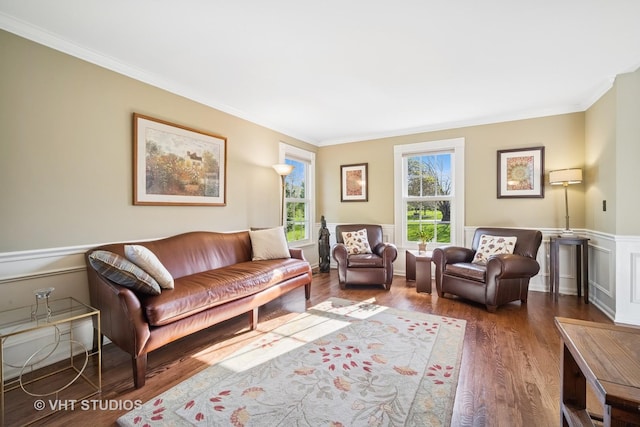 sitting room featuring crown molding, wood finished floors, and a wainscoted wall