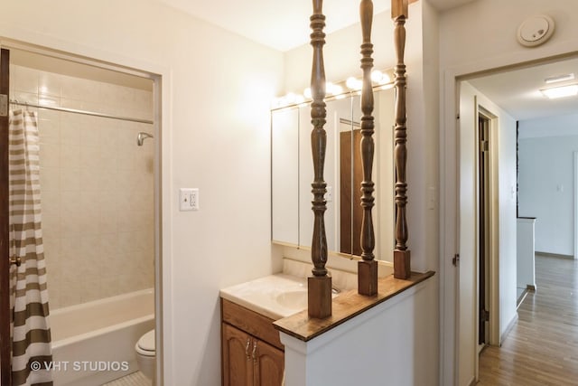 full bathroom with toilet, wood finished floors, vanity, baseboards, and shower / bathtub combination with curtain