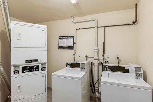 community laundry room with tile patterned floors, independent washer and dryer, and stacked washer / drying machine