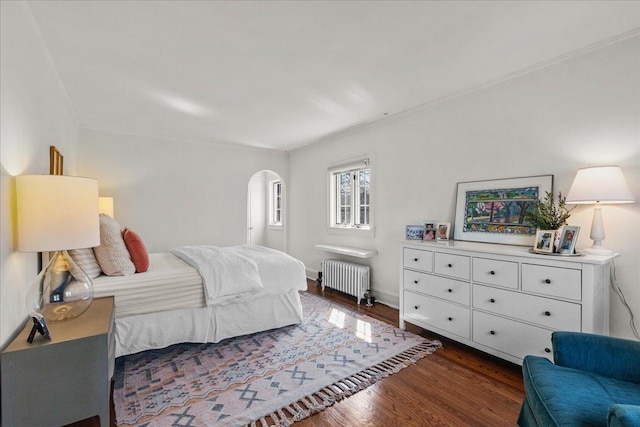 2341 Lincolnwood Dr, Evanston, IL 60201 - bedroom with radiator heating unit, wood finished floors, and arched walkways