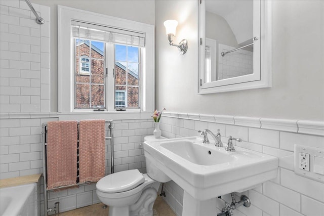 2341 Lincolnwood Dr, Evanston, IL 60201 - full bath featuring tile walls, toilet, a wainscoted wall, and a sink