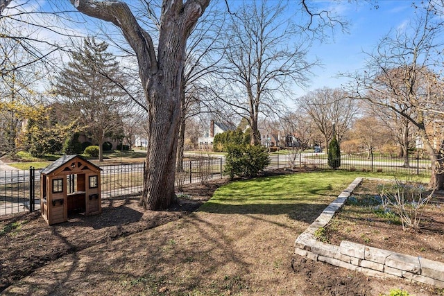 2341 Lincolnwood Dr, Evanston, IL 60201 - view of yard featuring fence, exterior structure, and an outbuilding