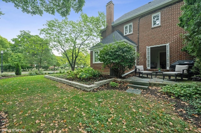 2341 Lincolnwood Dr, Evanston, IL 60201 - rear view of property featuring a patio area, a chimney, fence, a yard, and brick siding