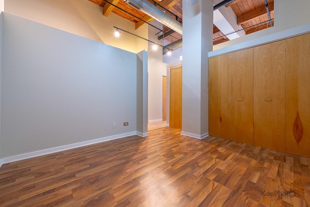 below grade area with wood ceiling, baseboards, and wood finished floors