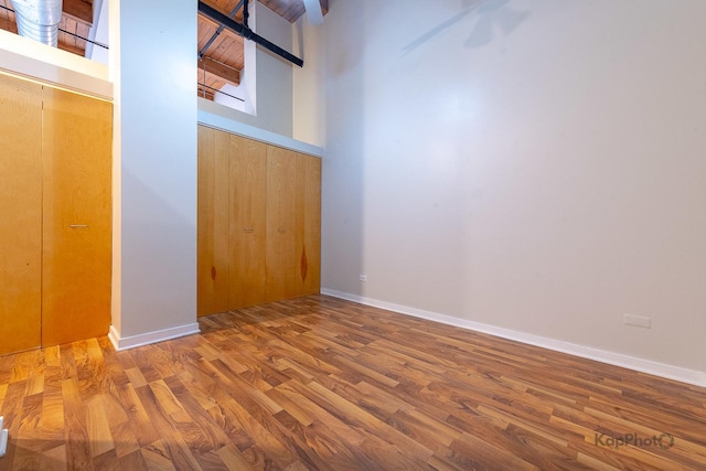 entrance foyer with baseboards and wood finished floors