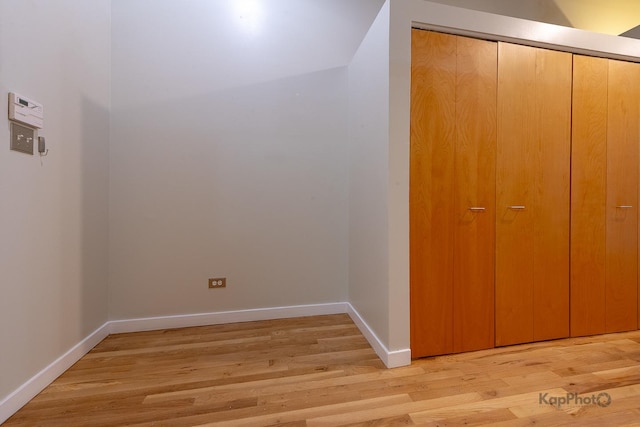 interior space featuring light wood-type flooring and baseboards