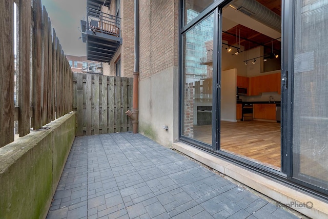 view of patio featuring a sink and fence