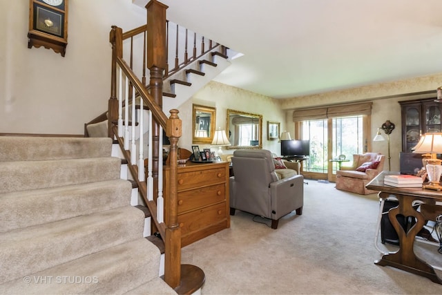 living room with stairs and light colored carpet