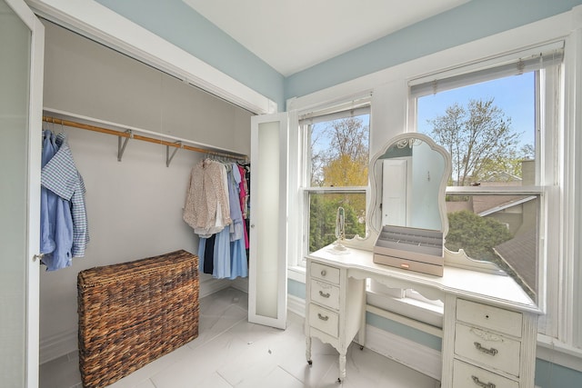 spacious closet with marble finish floor