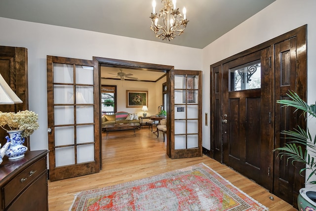 entryway featuring a chandelier, a healthy amount of sunlight, and light wood-style flooring
