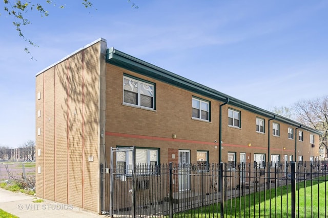 7010 S E End Ave Unit 4, Chicago, IL 60649 - exterior space with brick siding, fence, and a lawn