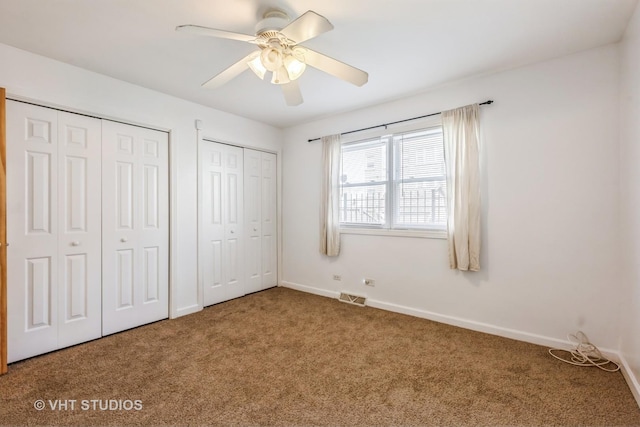 7010 S E End Ave Unit 4, Chicago, IL 60649 - unfurnished bedroom with carpet floors, two closets, ceiling fan, baseboards, and visible vents