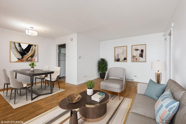 7010 S E End Ave Unit 4, Chicago, IL 60649 - living area with wood finished floors, visible vents, and baseboards