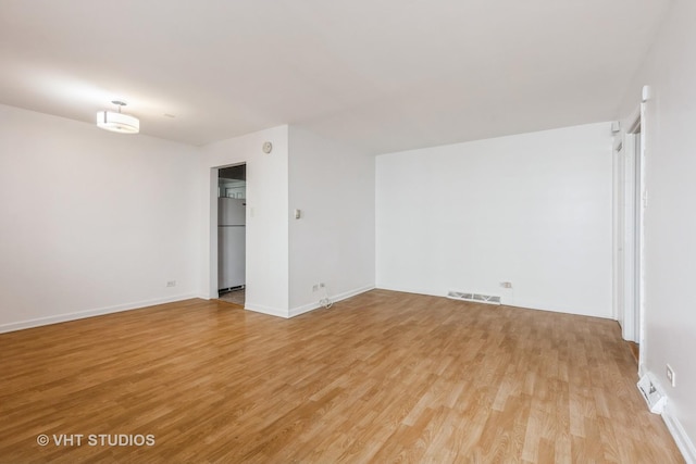 7010 S E End Ave Unit 4, Chicago, IL 60649 - spare room with visible vents, baseboards, and light wood-type flooring