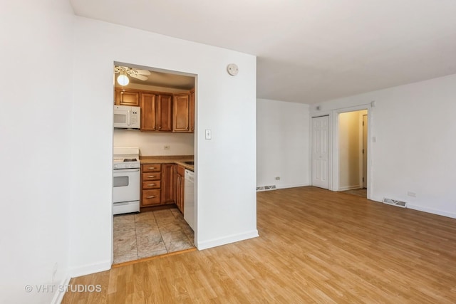 7010 S E End Ave Unit 4, Chicago, IL 60649 - kitchen with brown cabinets, visible vents, white appliances, and light wood-style floors
