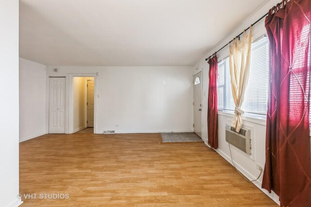 7010 S E End Ave Unit 4, Chicago, IL 60649 - empty room with baseboards, visible vents, and light wood finished floors