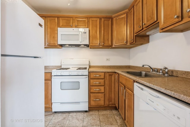 7010 S E End Ave Unit 4, Chicago, IL 60649 - kitchen with white appliances, brown cabinetry, and a sink