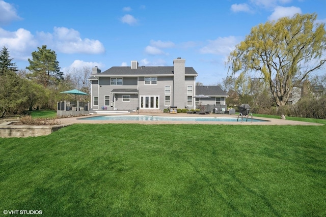 5364 Hedgewood Ct, Long Grove, IL 60047 - rear view of property with a chimney, an outdoor pool, a yard, french doors, and a patio area