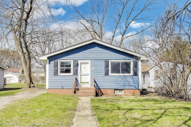 bungalow-style house with a front lawn